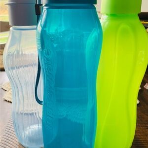 Tupperware Trio: Blue, Clear, and Neon Large Green Water Bottles